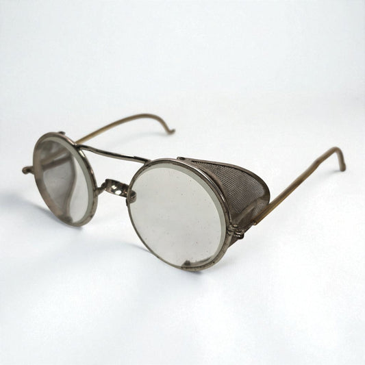 Vintage-style eyeglasses with round lenses and metal frame on a white background