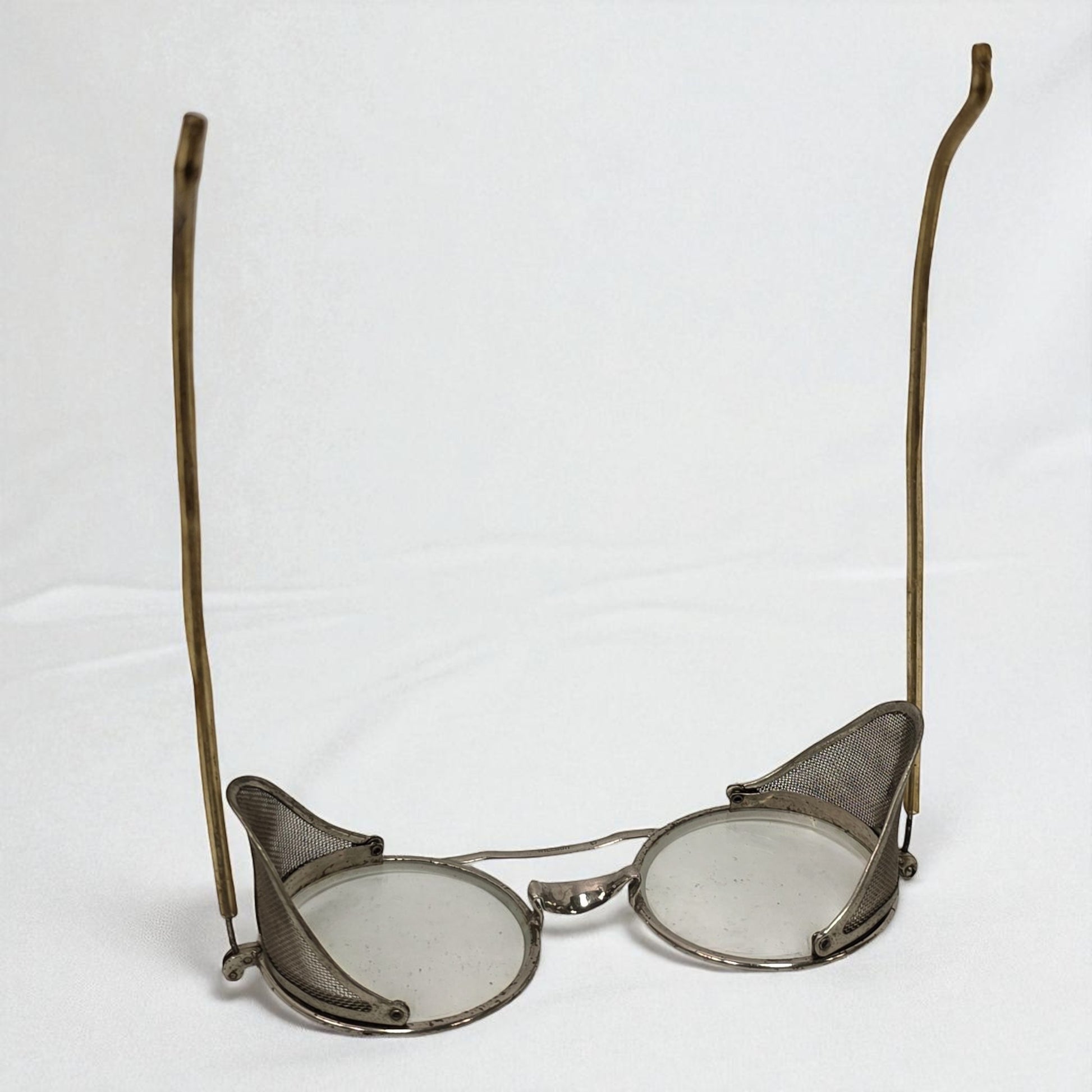 Vintage eyeglasses with metal frames on a white background