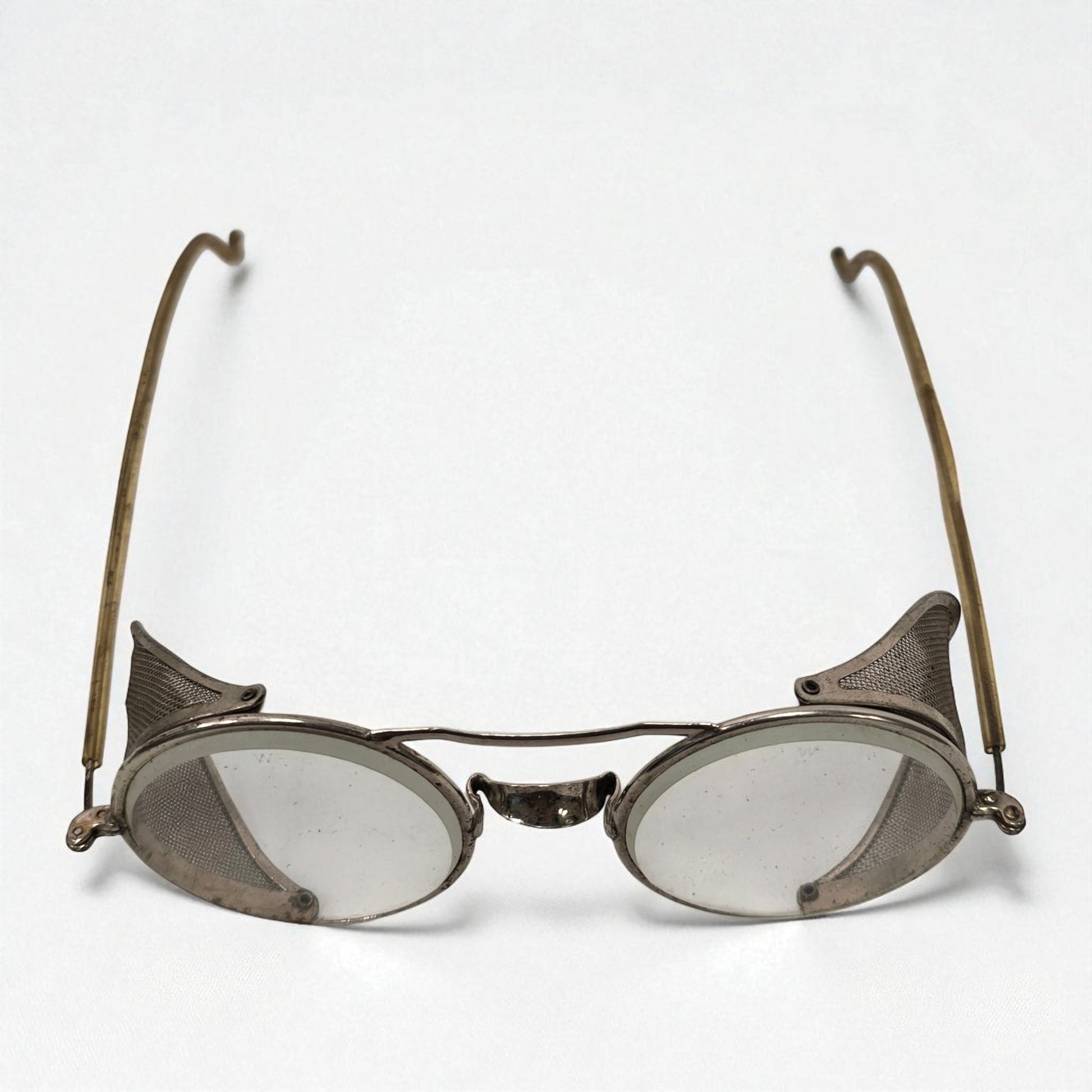 Pair of vintage eyeglasses with metal frames on a white background