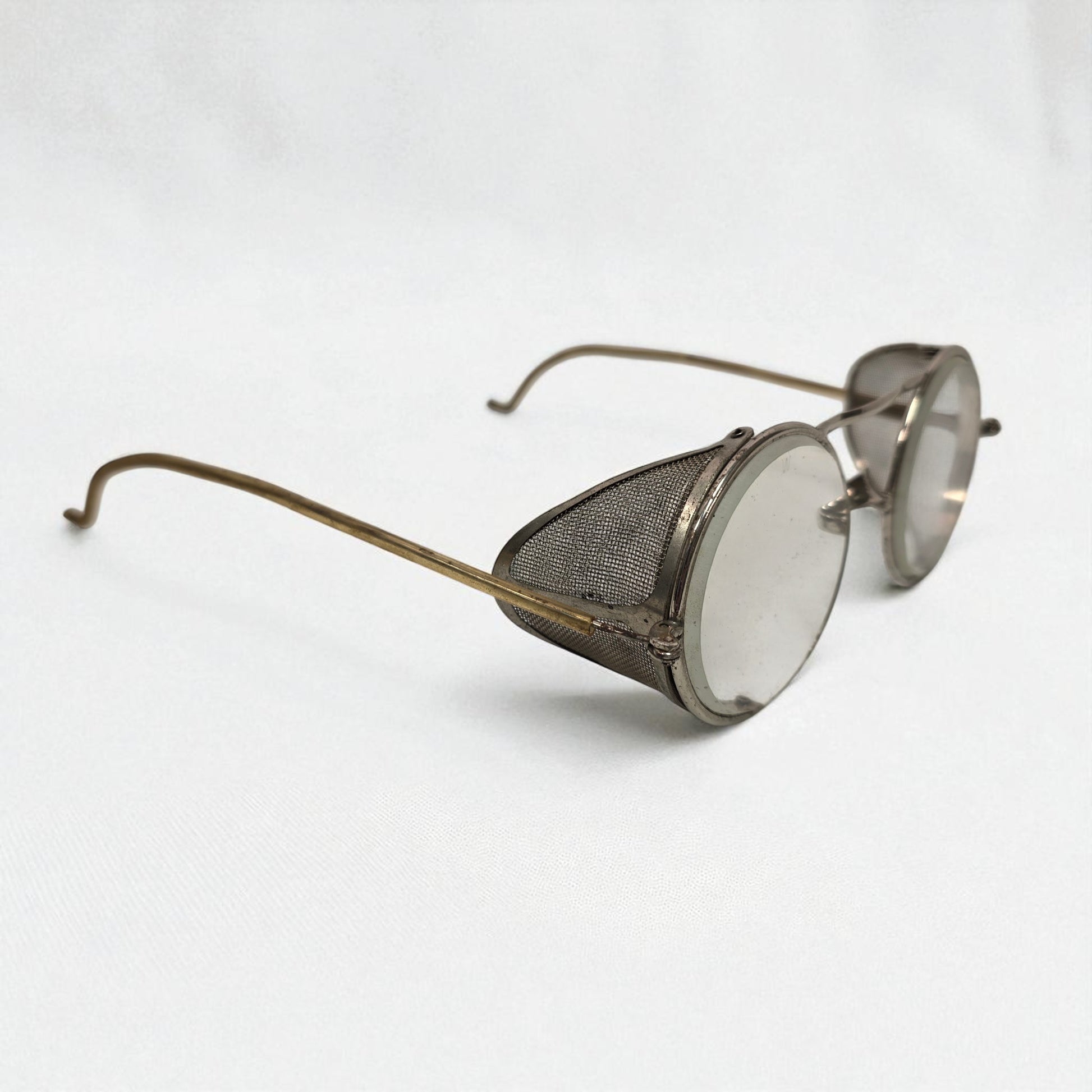 Vintage-style sunglasses with mesh design on a white background