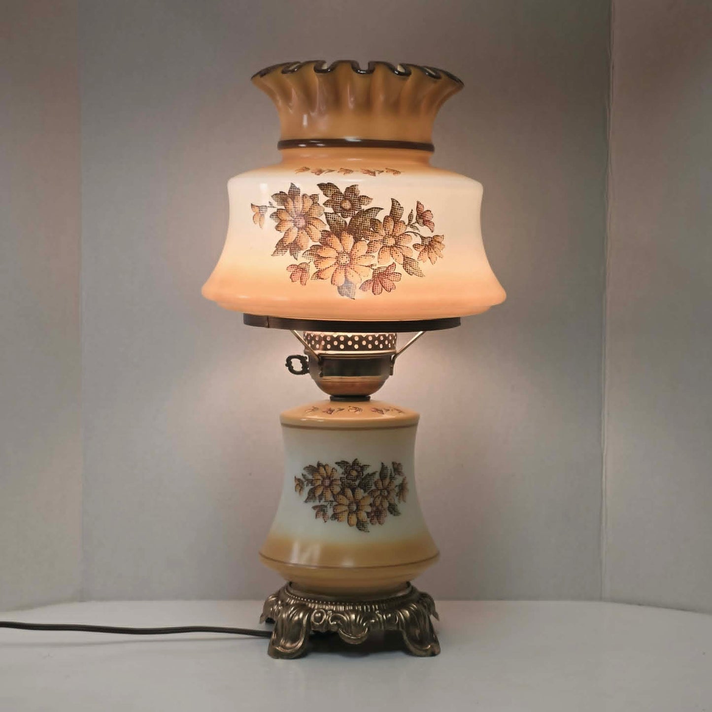 Vintage harvest gold hurricane lamp with needlepoint floral shade and font featuring tri-light operation.