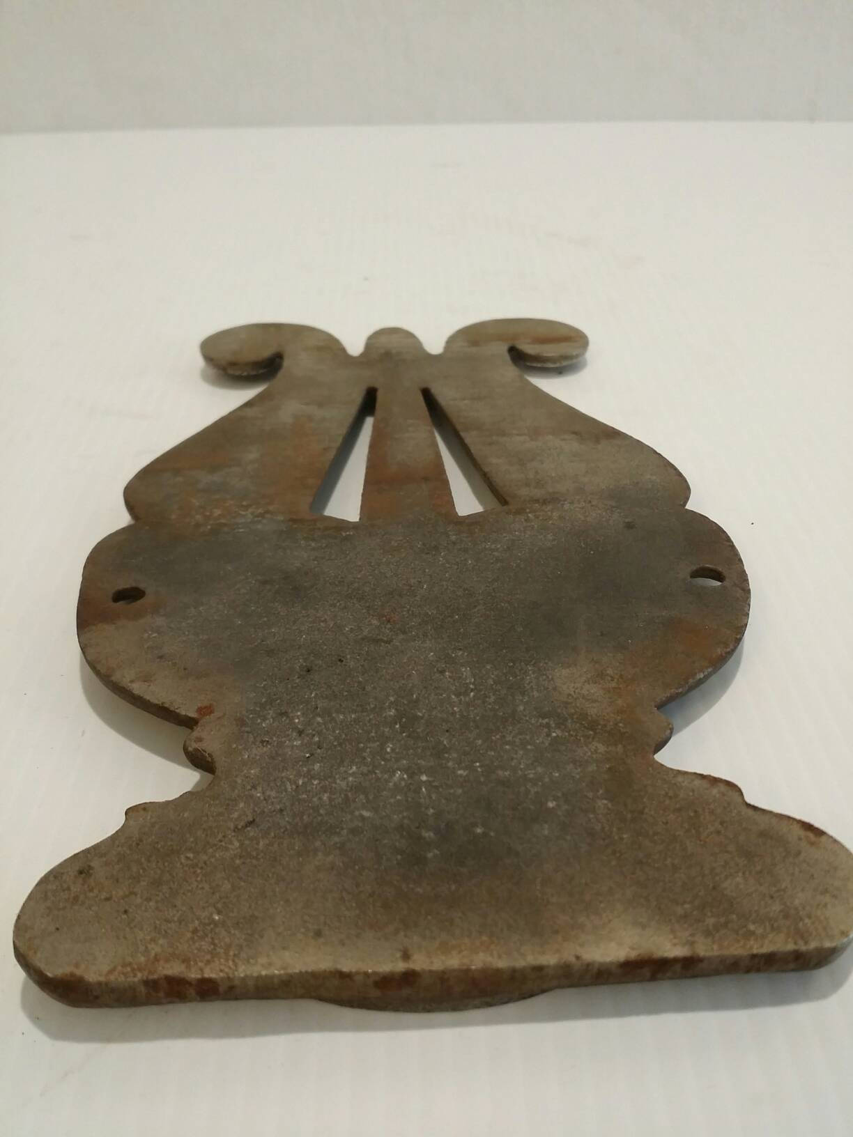 pair of cast iron harp plaques