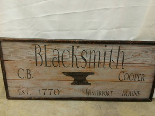 wooden framed blacksmiths sign