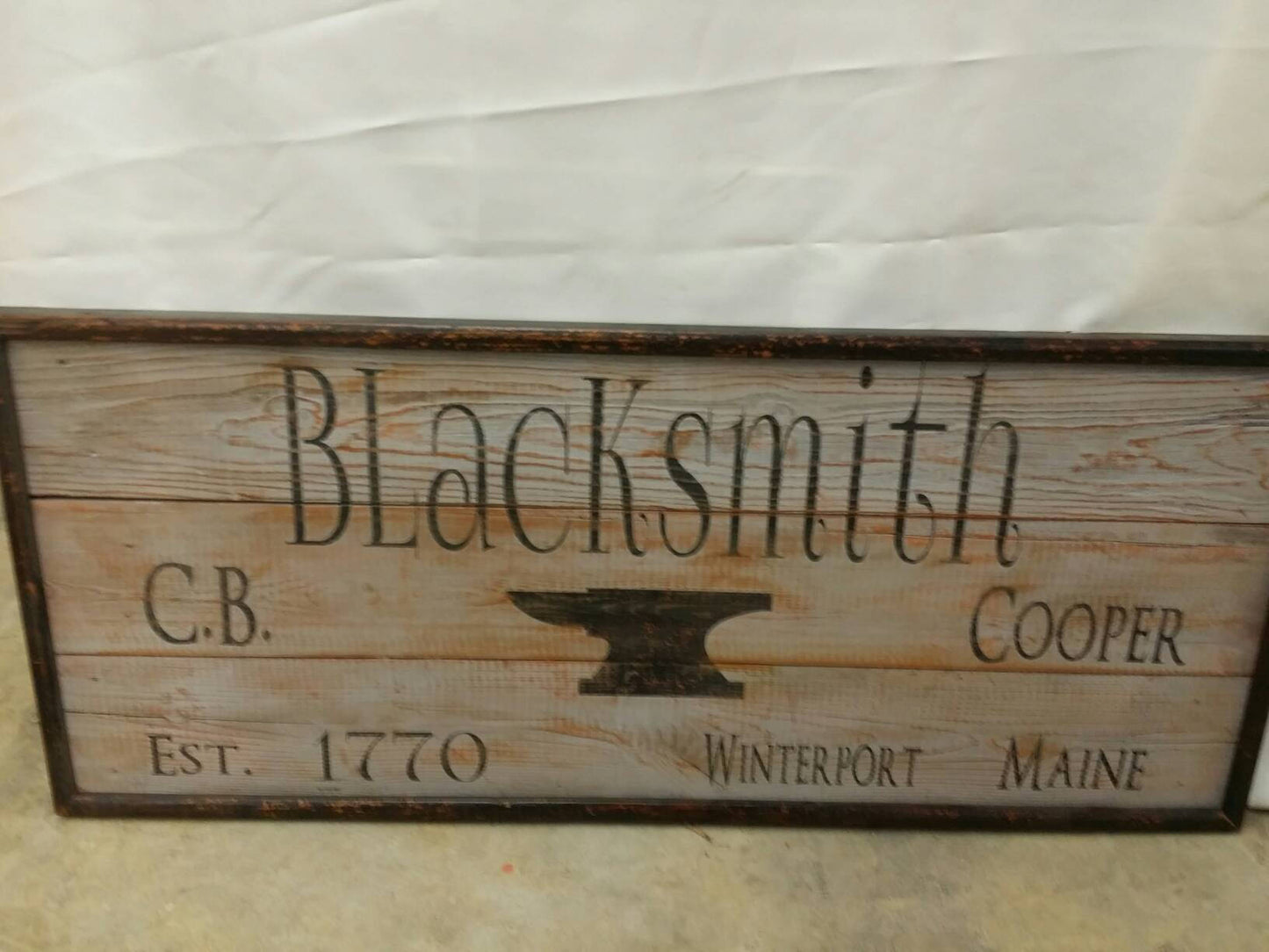 wooden framed blacksmiths sign