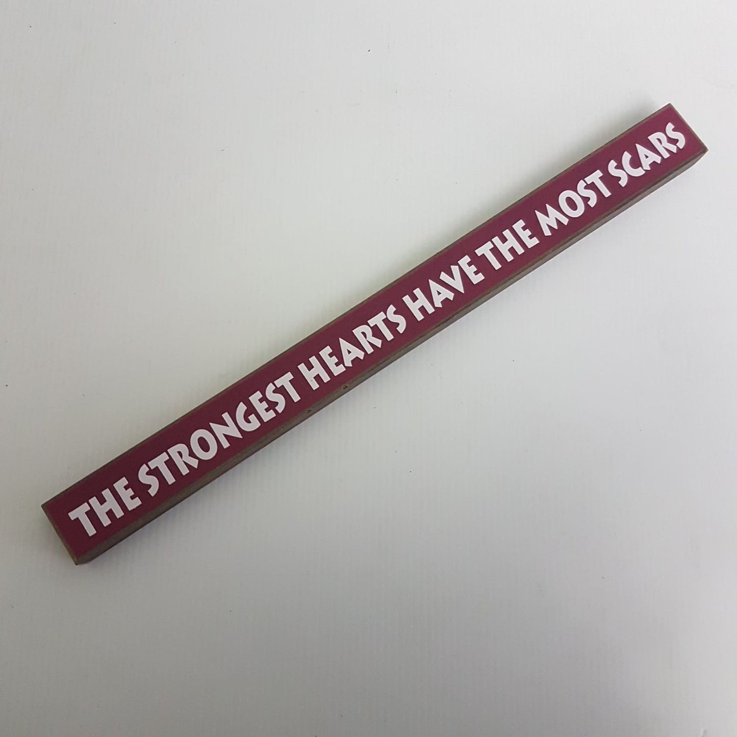 inspirational desktop sign " the strongest hearts have the most scars "