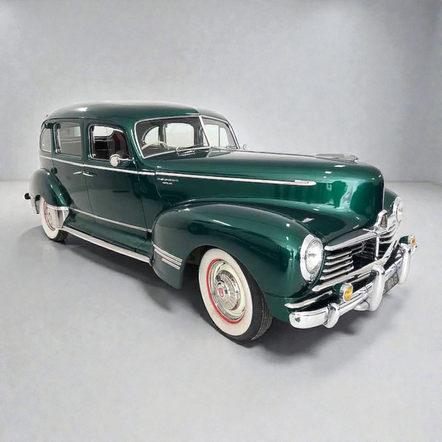 Vintage green car on a gray background