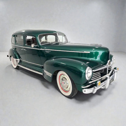 Vintage green car on a gray background