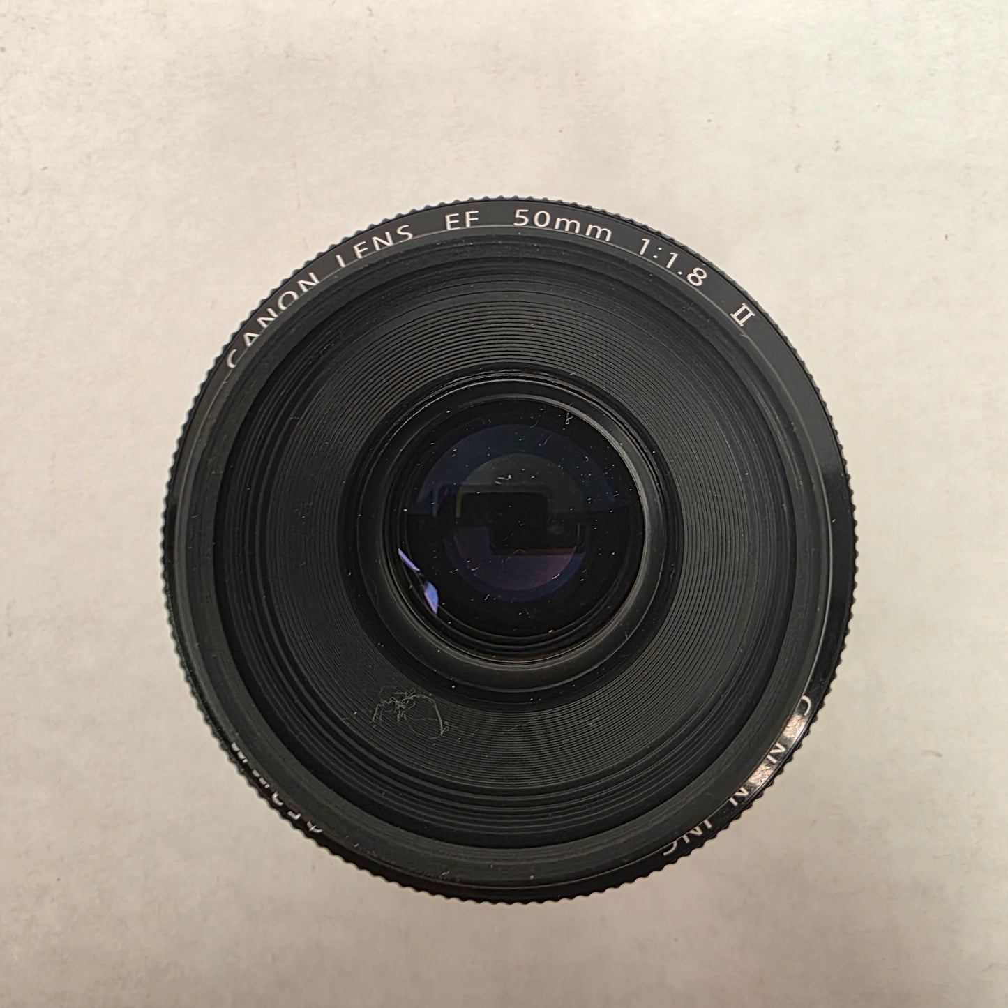 Canon camera lens on a beige background