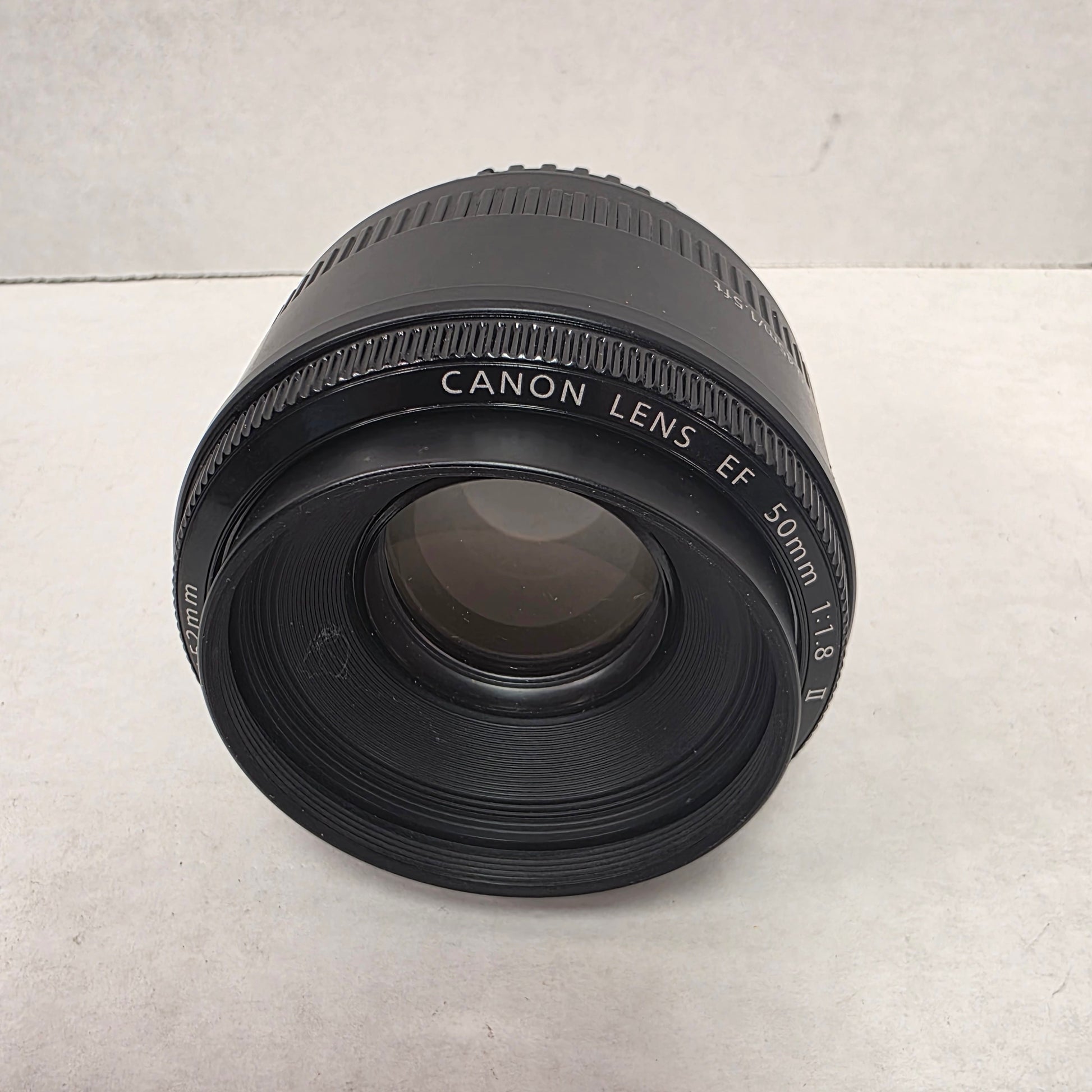 Canon camera lens on a light gray background