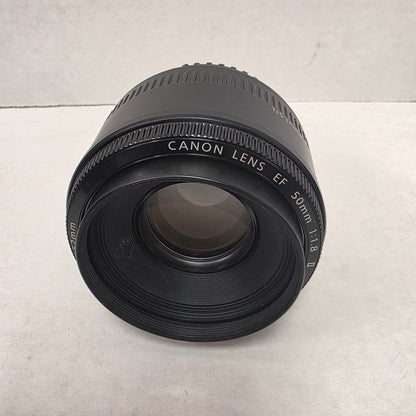 Canon camera lens on a light gray background