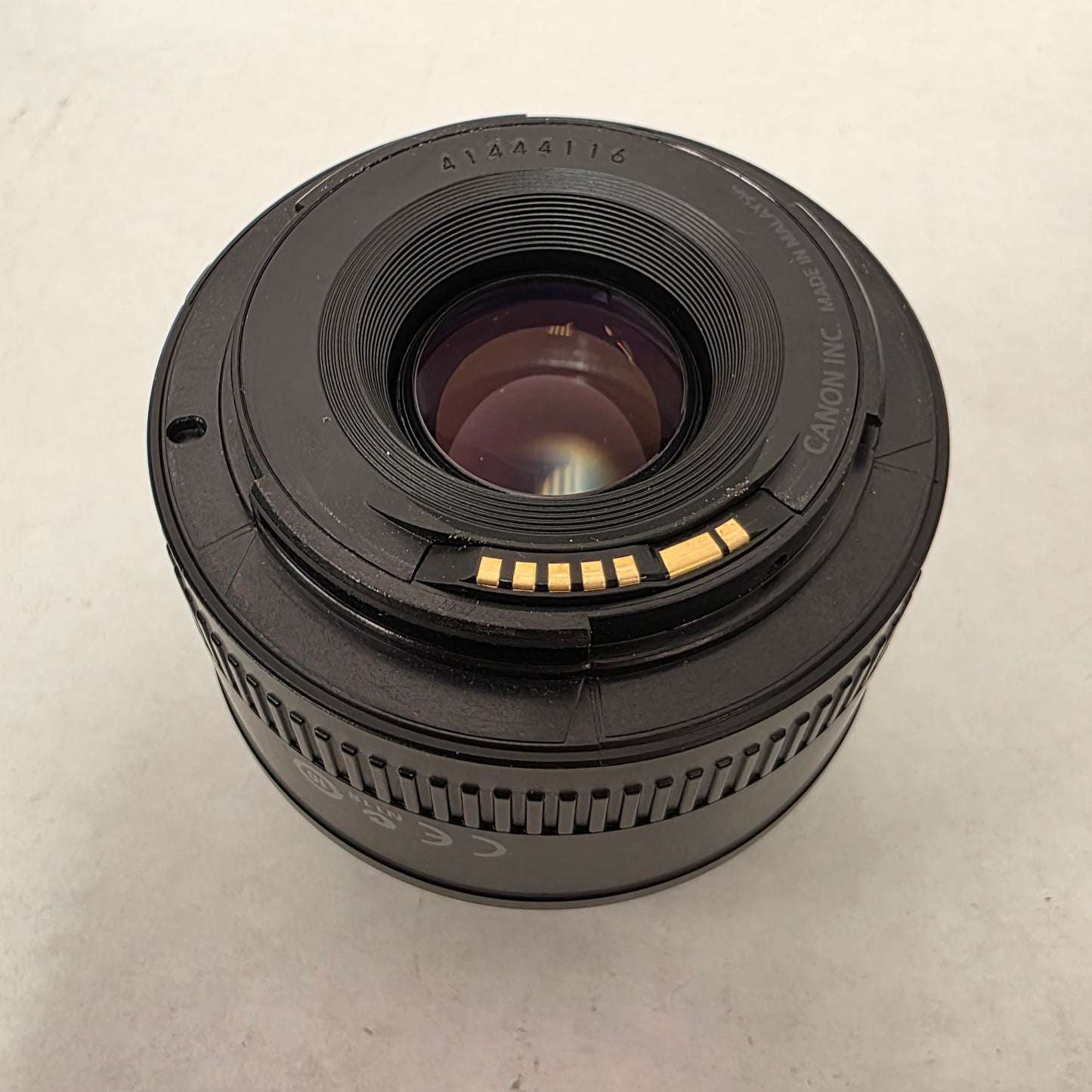 Canon camera lens on a light gray background