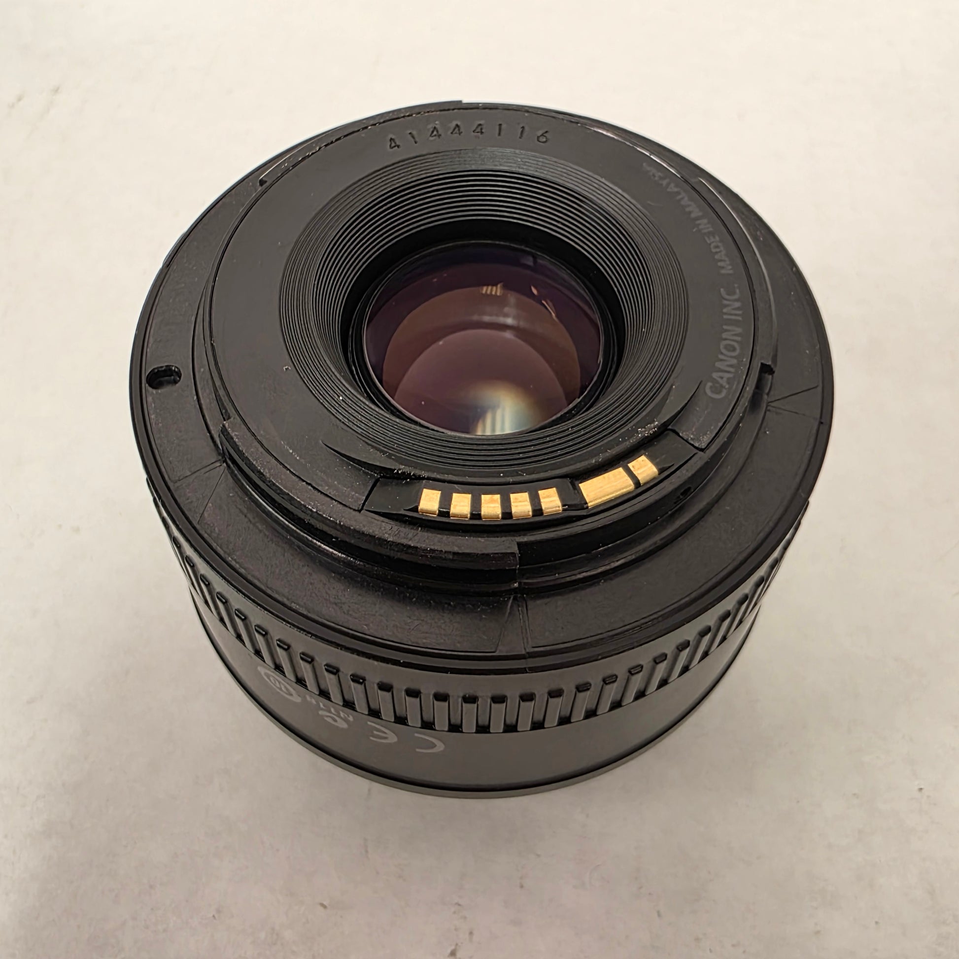 Canon camera lens on a light gray background