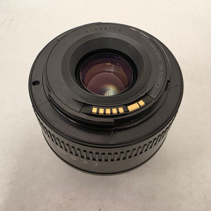 Canon camera lens on a light gray background