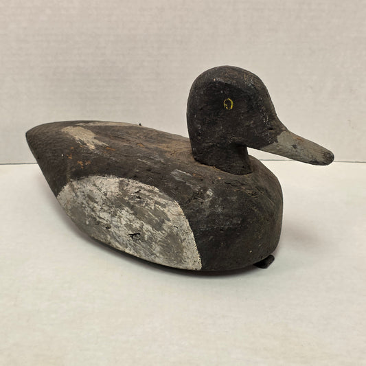 Wooden duck decoy on a light gray background