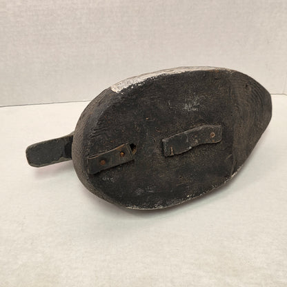Black leather shoe with a strap on a light gray background