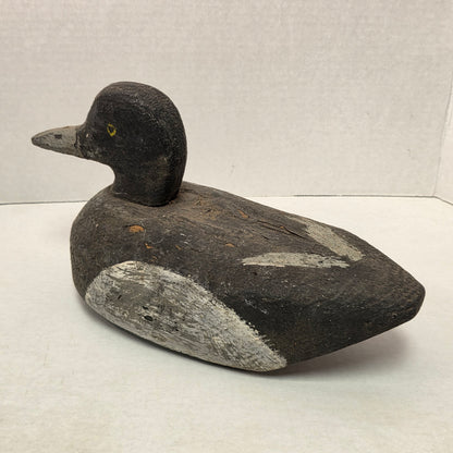 Wooden duck decoy on a light gray background