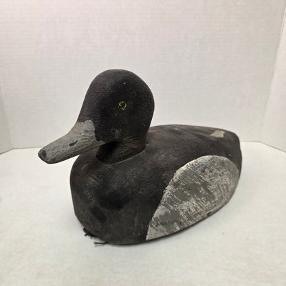 Black and gray duck decoy on a white background