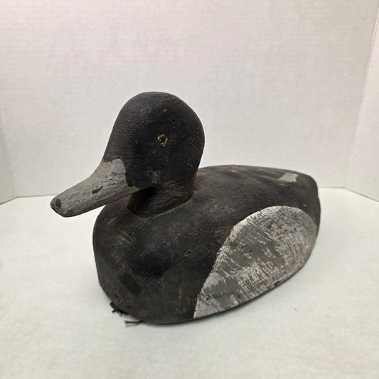 Black and gray duck decoy on a white background
