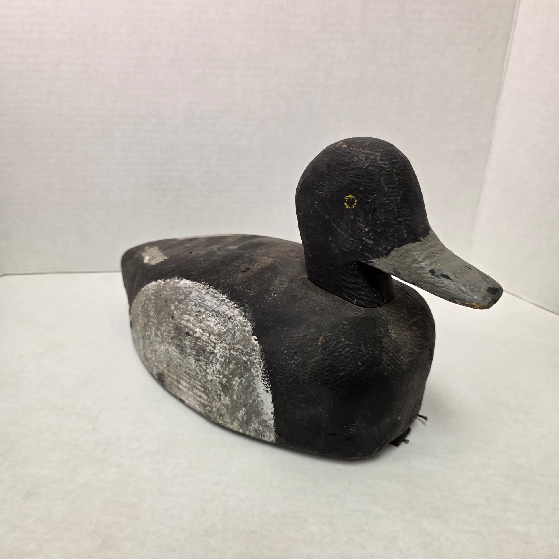 Wooden duck decoy on a white background