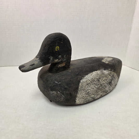 Black and gray duck decoy on a white background
