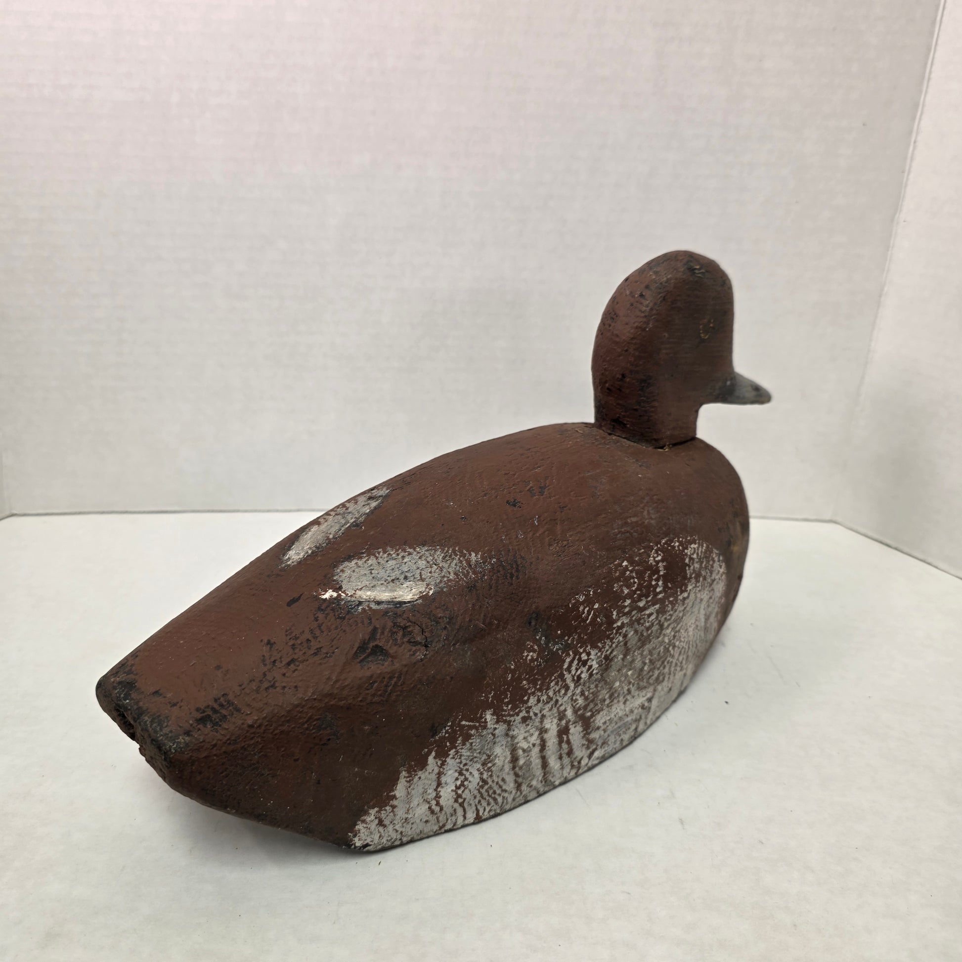 Wooden duck decoy on a white background