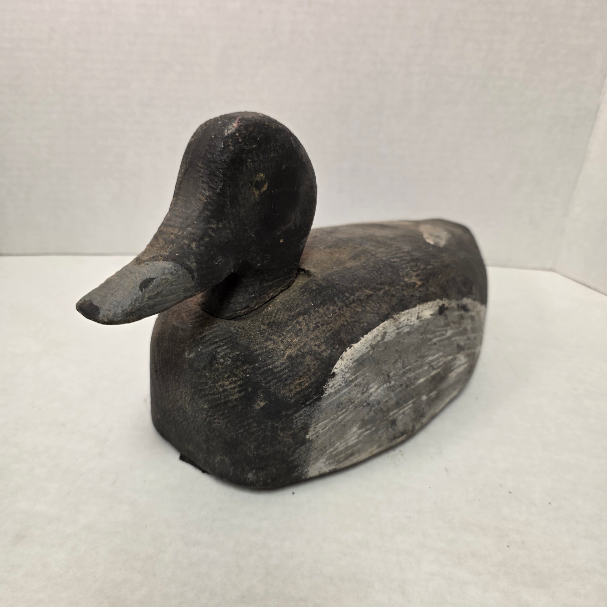 Wooden duck decoy on a white background