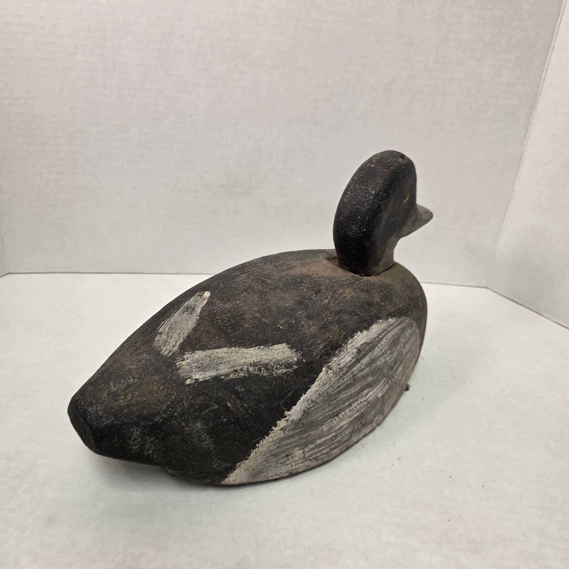 Wooden duck decoy on a white background