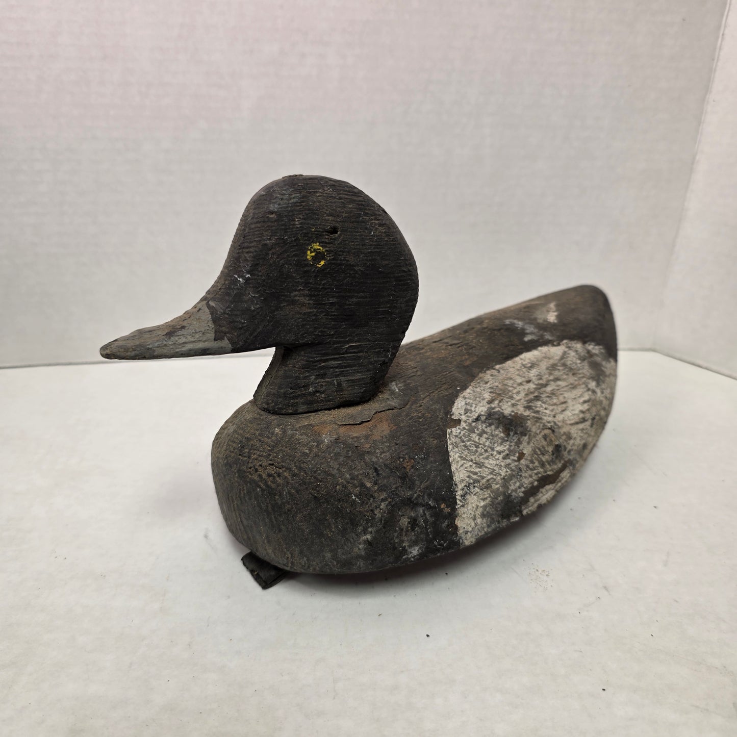 Wooden duck decoy on a white background