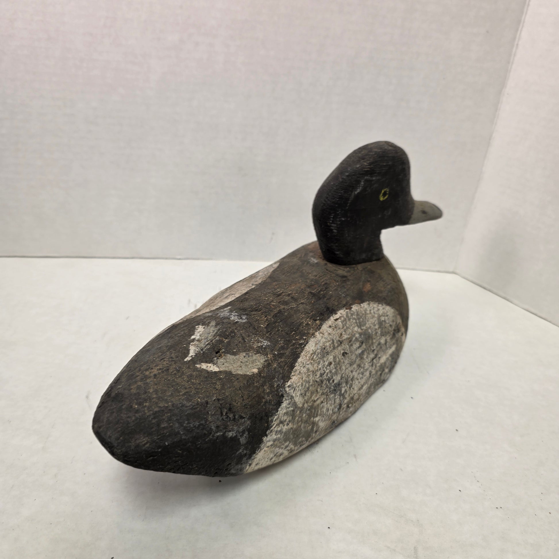 Wooden duck decoy on a white background
