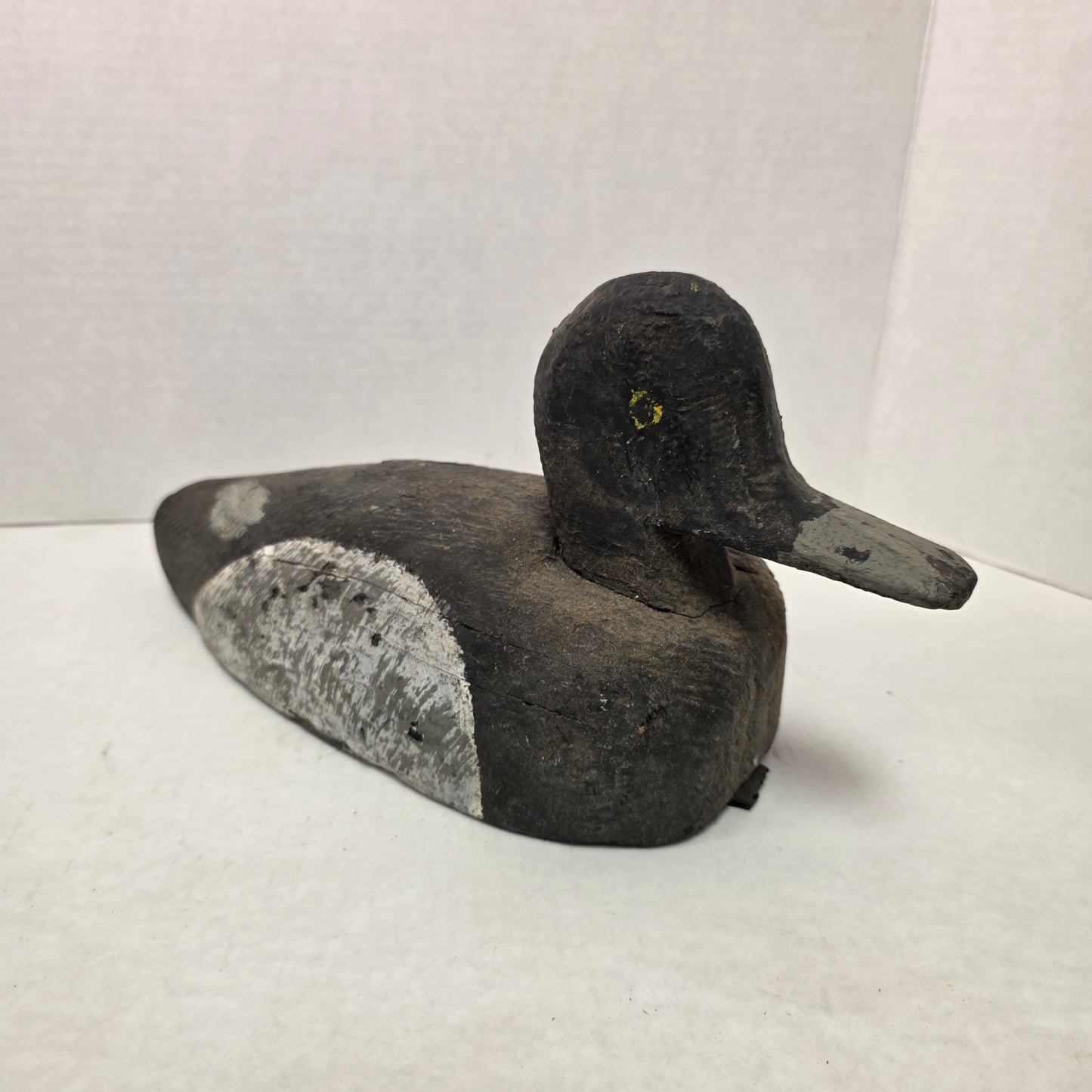 Wooden duck decoy on a white background