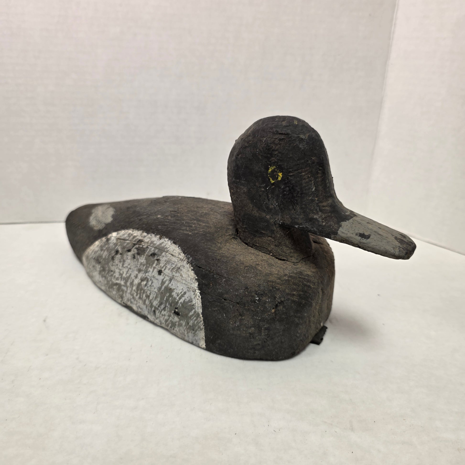 Wooden duck decoy on a white background