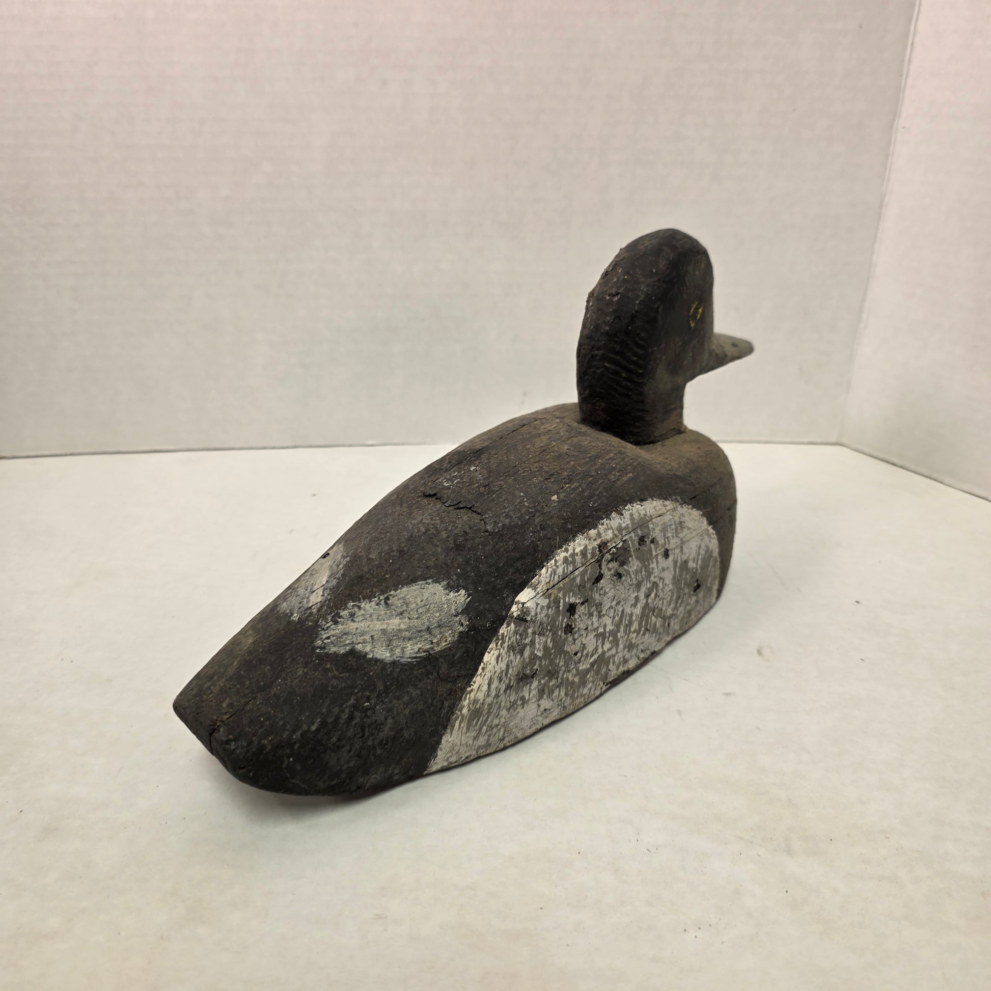 Wooden duck decoy on a white background