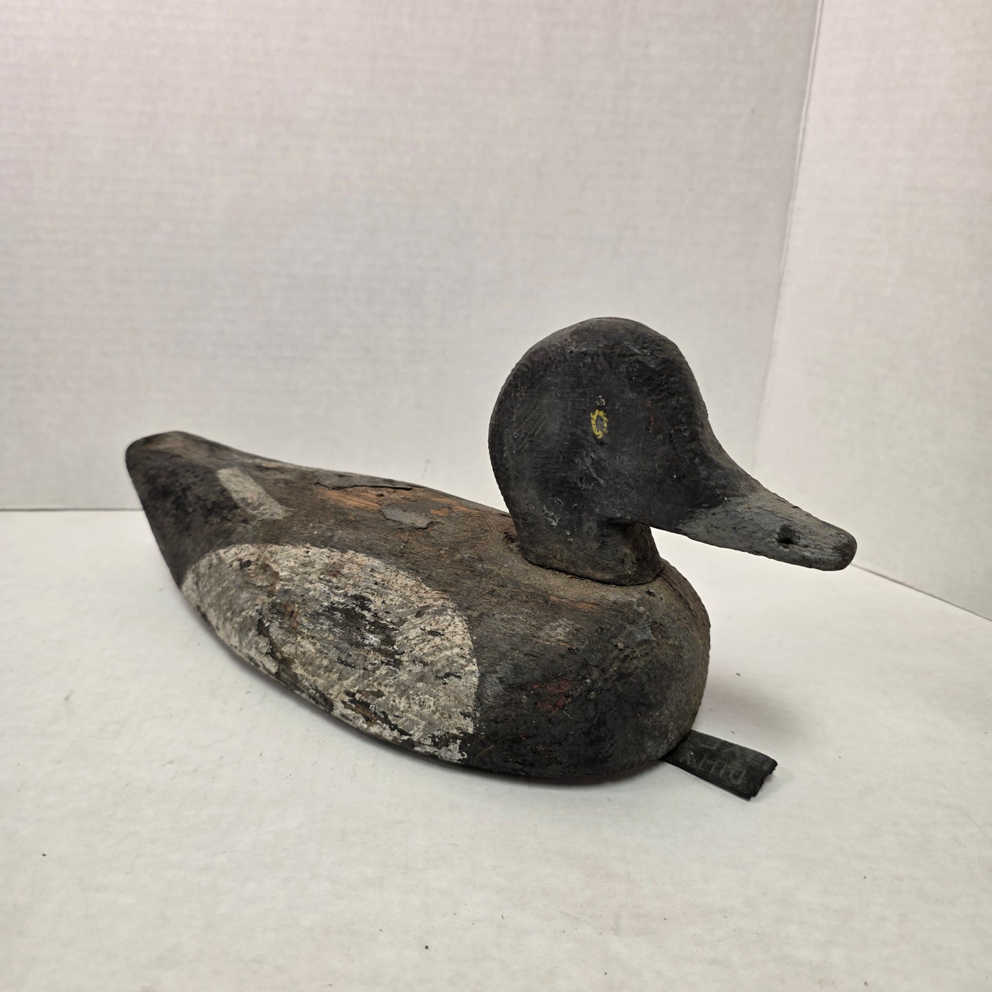 Wooden duck decoy on a white background