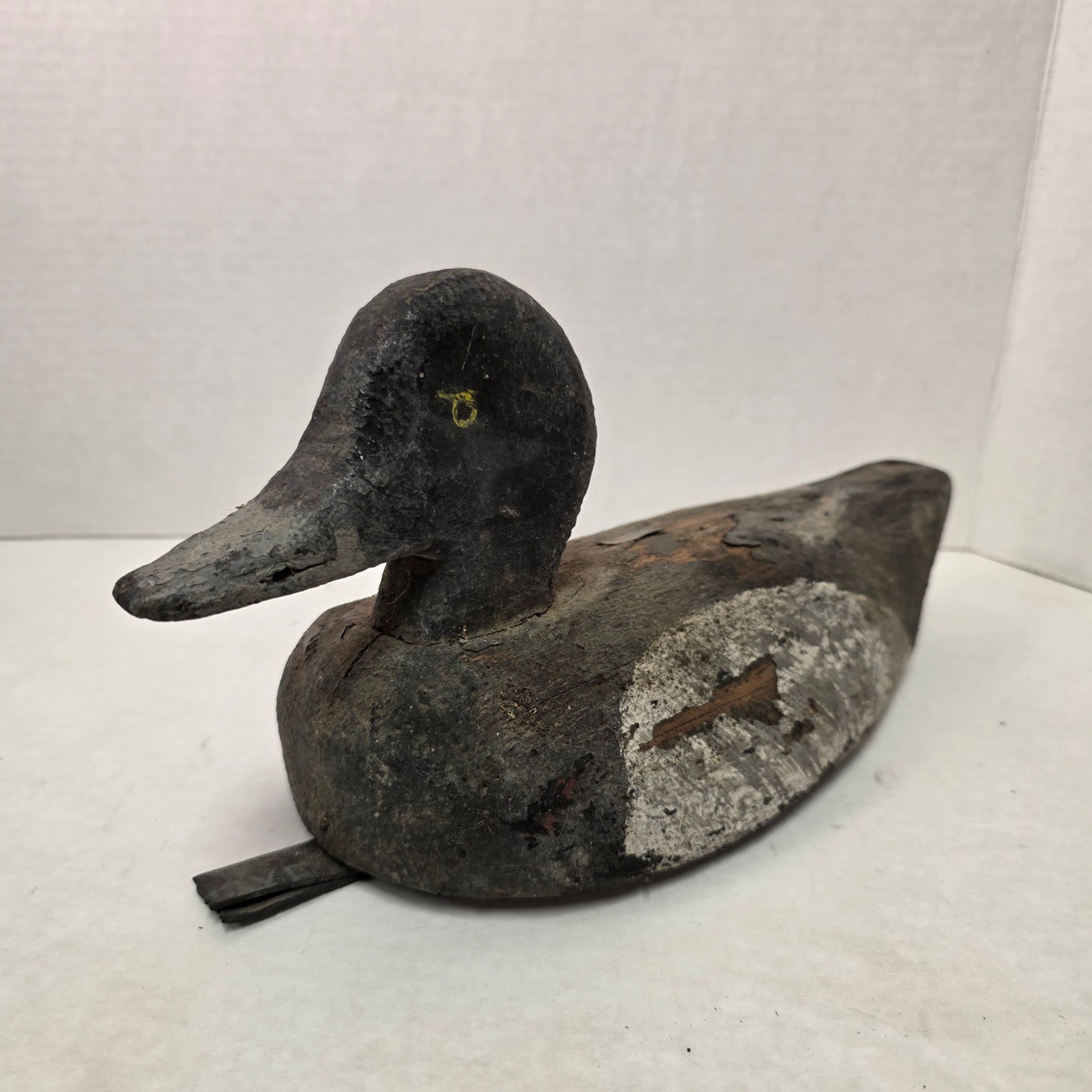 Two wooden duck decoys on a white background