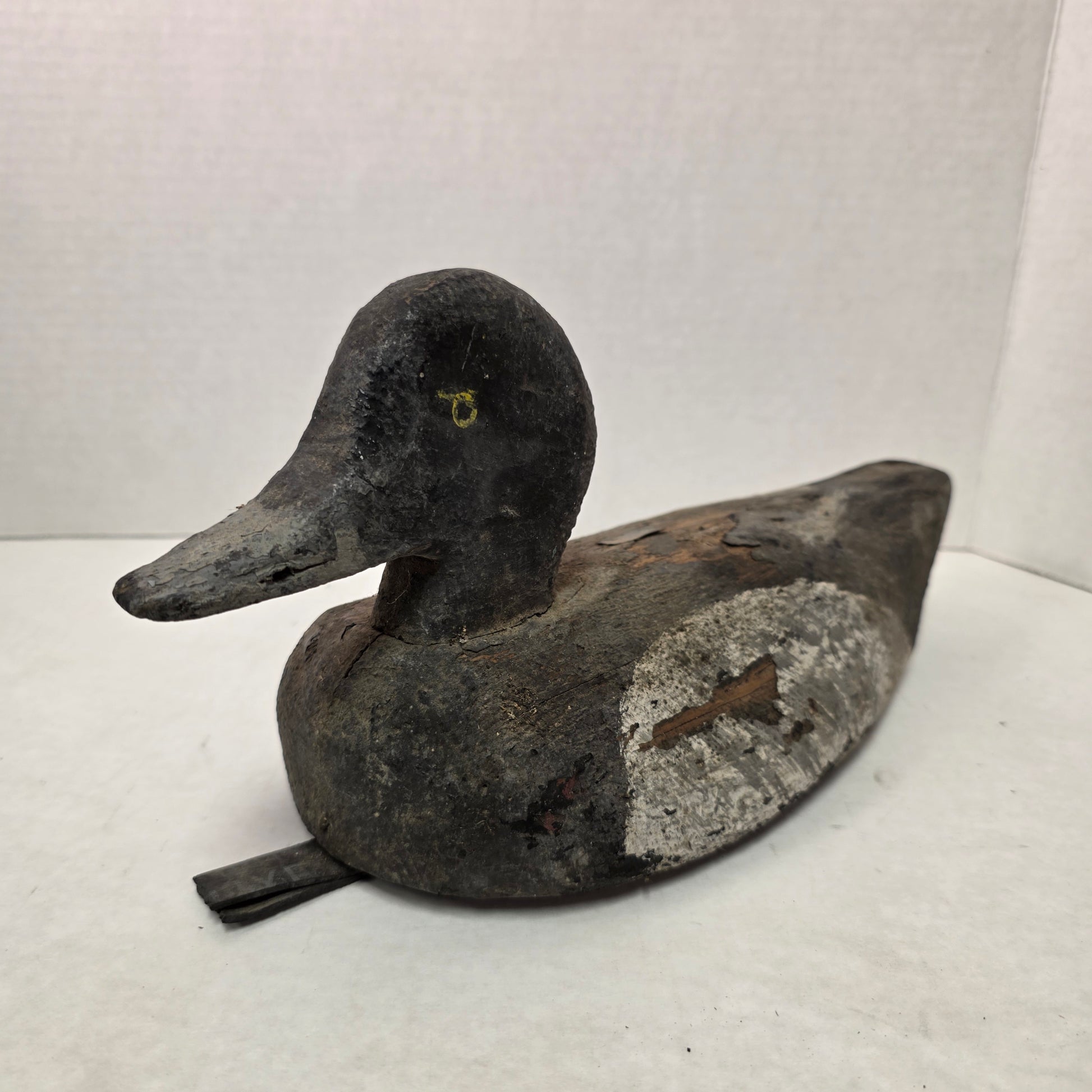 Two wooden duck decoys on a white background