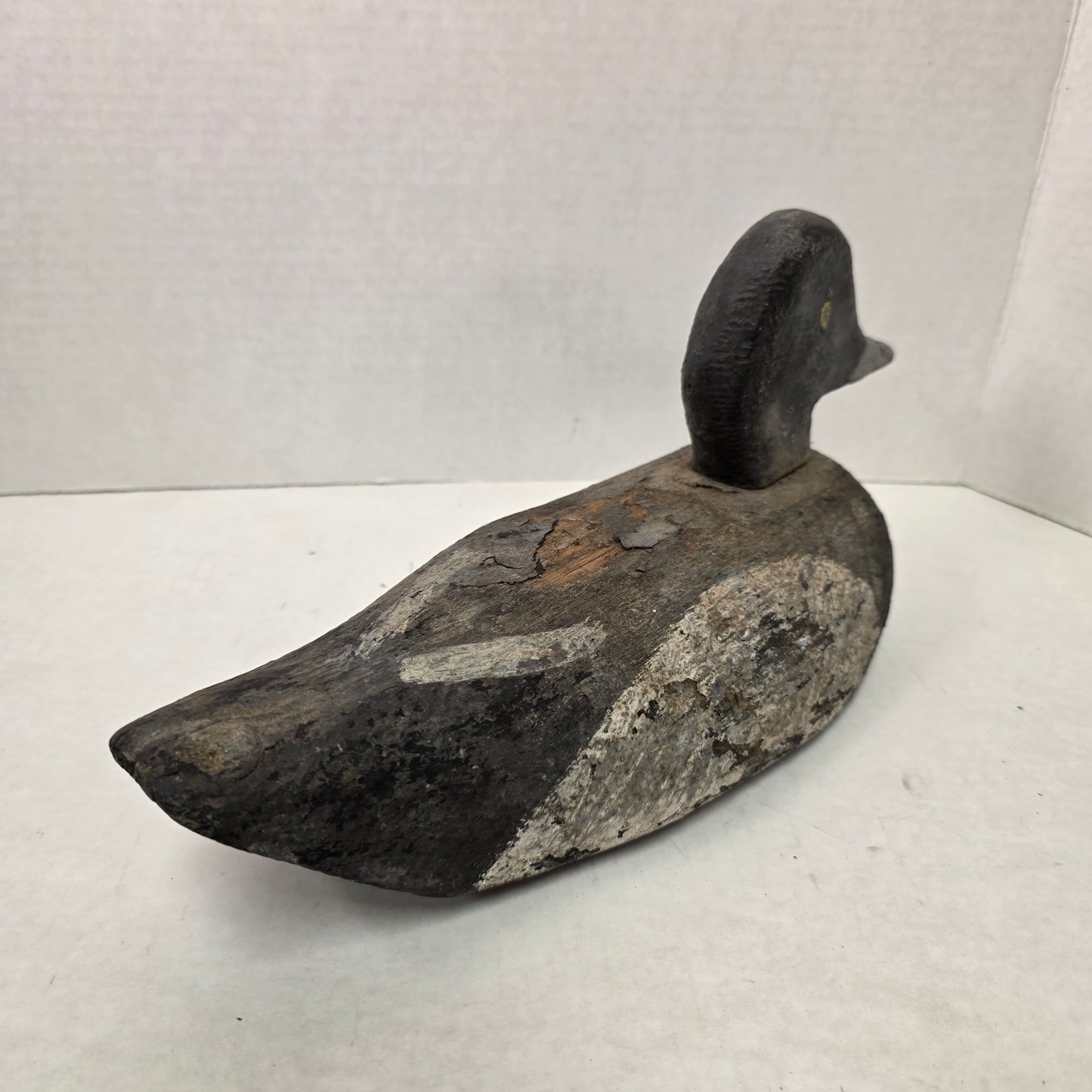 Wooden duck decoy on a white background