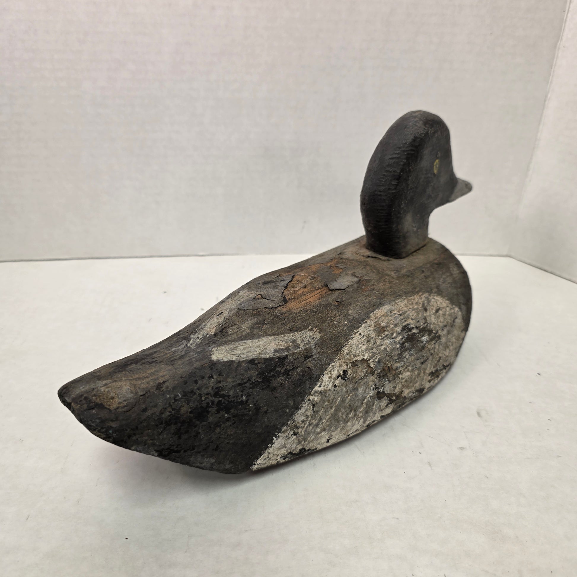 Wooden duck decoy on a white background