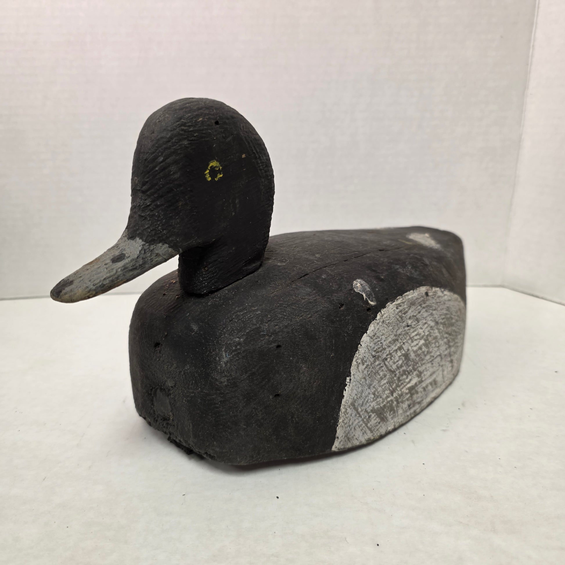 Wooden duck decoy on a white background
