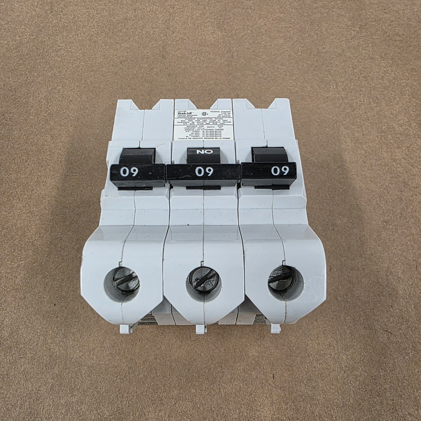 Three-phase electrical breaker on a brown background