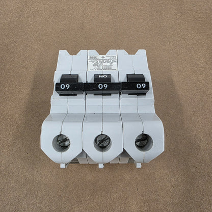 Three-phase electrical breaker on a brown background