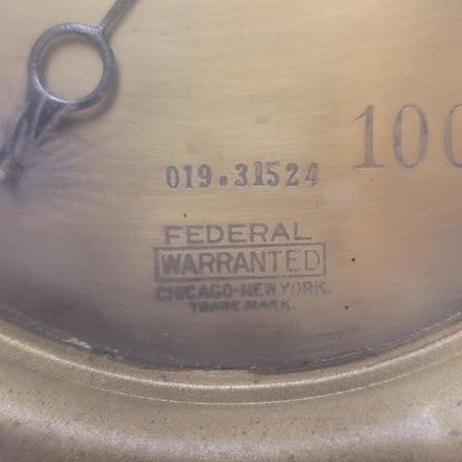 Close-up of a metal object with 'Federal Warranted' branding and numbers.