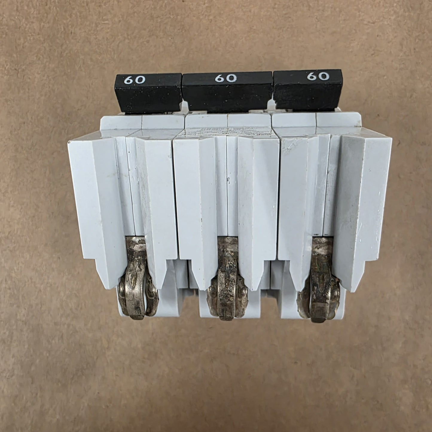 Electrical breaker panel with multiple circuit breakers on a brown background
