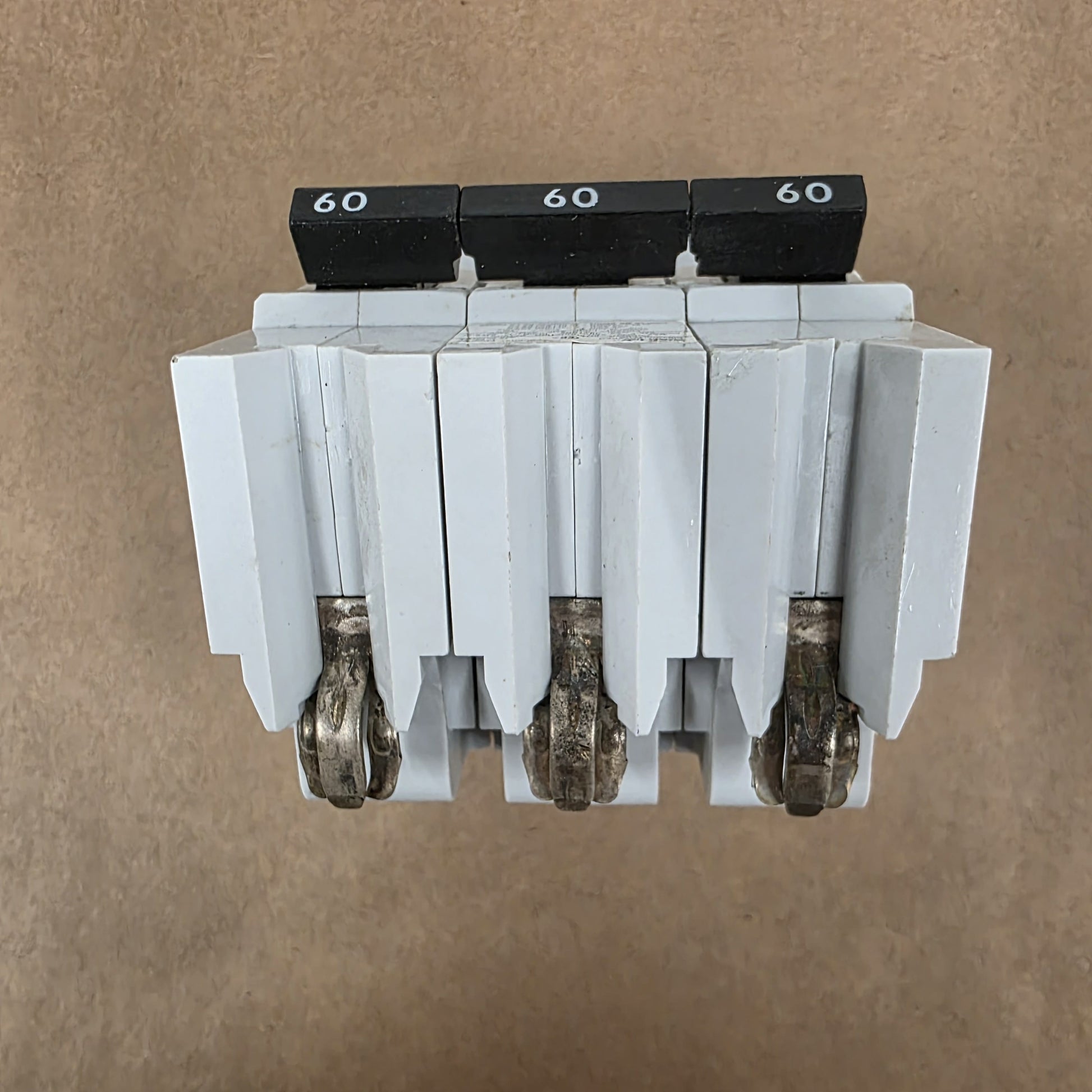 Electrical breaker panel with multiple circuit breakers on a brown background