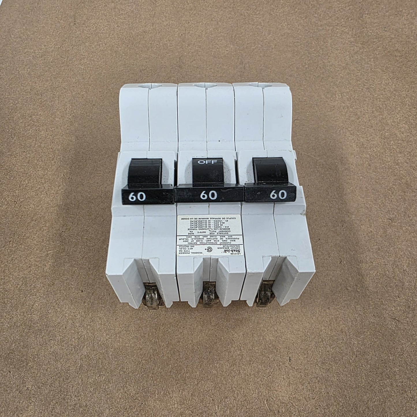 Three-phase electrical breaker on a brown background