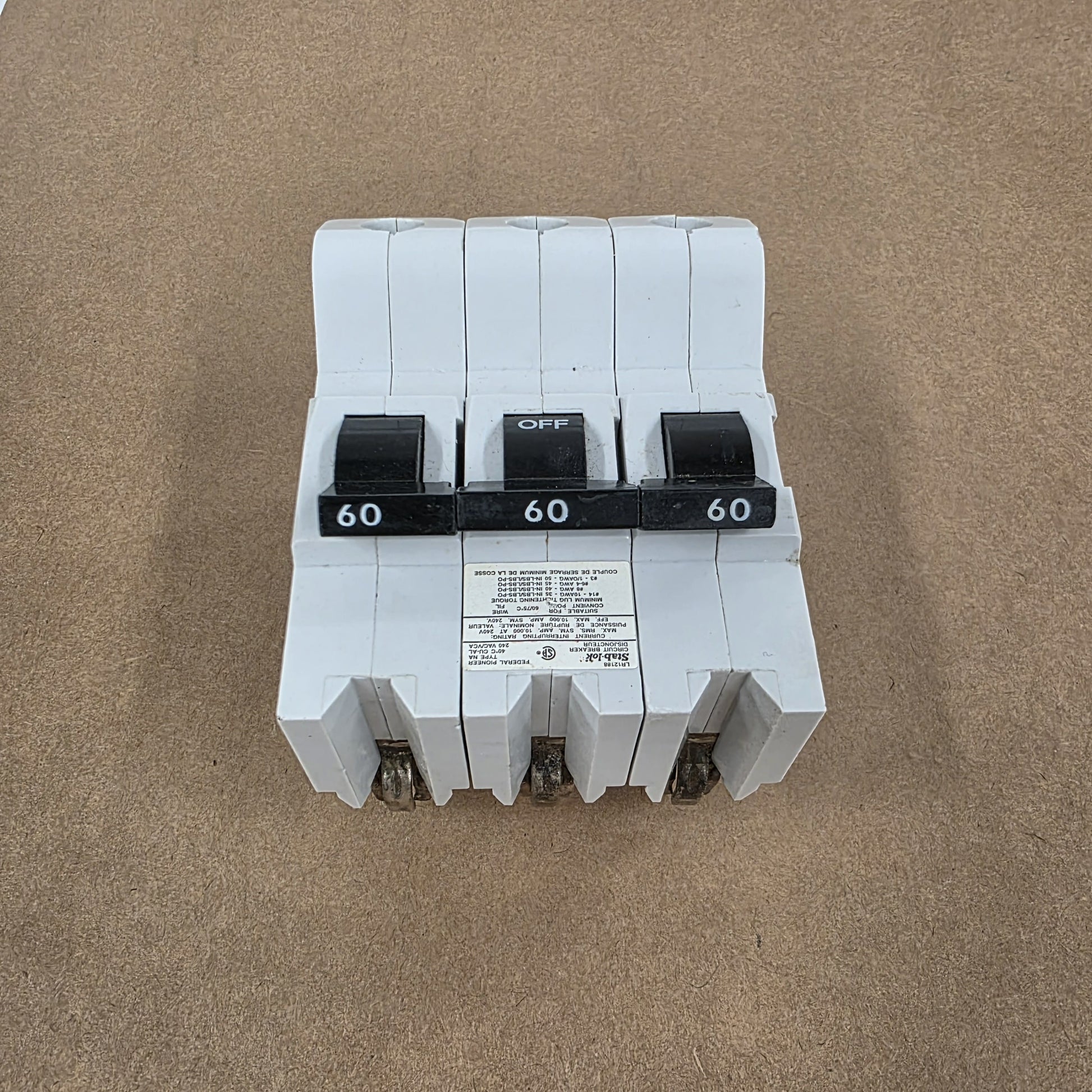 Three-phase electrical breaker on a brown background