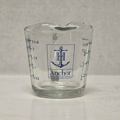 Vintage Anchor Hocking glass measuring cup with Imperial and metric measurements.
