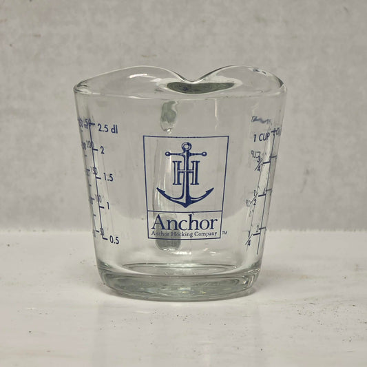 Vintage Anchor Hocking glass measuring cup with Imperial and metric measurements.
