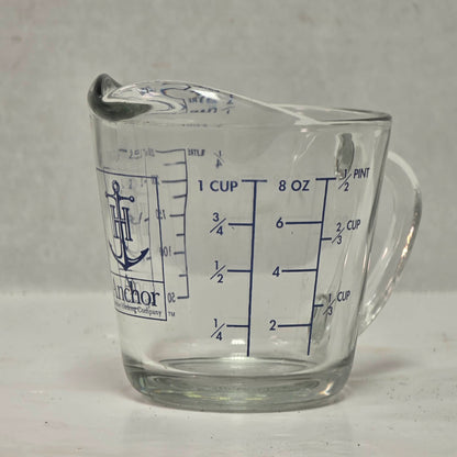 Vintage Anchor Hocking glass measuring cup with Imperial and metric measurements.
