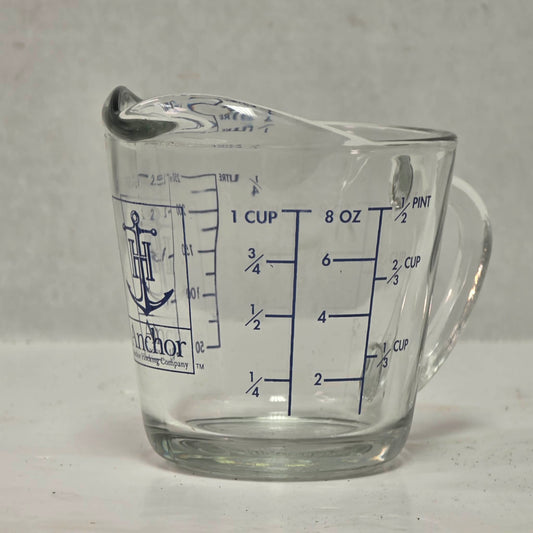 Vintage Anchor Hocking glass measuring cup with Imperial and metric measurements.
