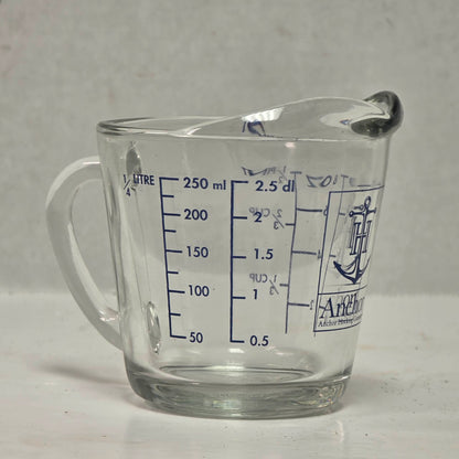 Vintage Anchor Hocking glass measuring cup with Imperial and metric measurements.
